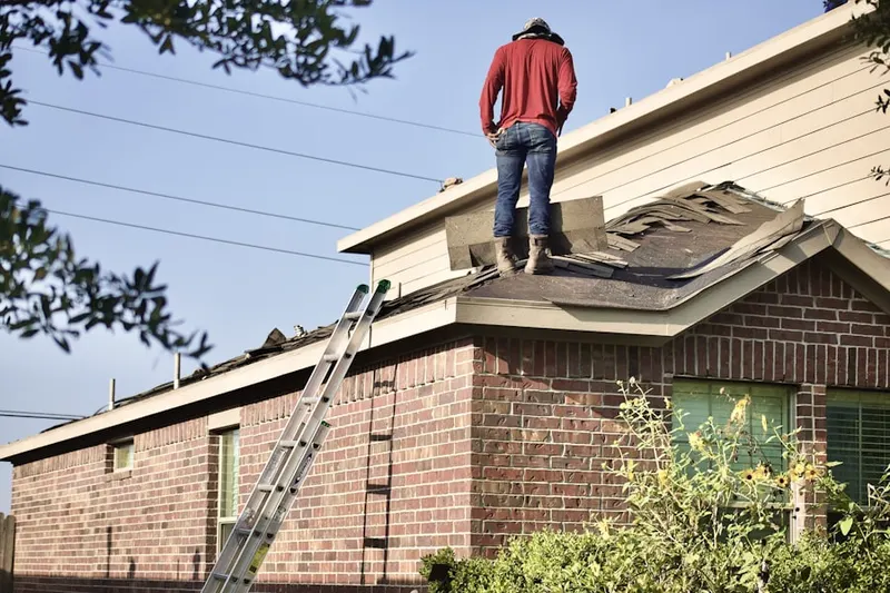 Professional roofer working on a residential roof in Waggaman